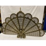 A VINTAGE BRASS PEACOCK FAN FIRE SCREEN WITH WINGED GRIFFIN TO THE BASE, HEIGHT 63CM