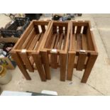 A SET OF THREE WOODEN TROUGH PLANTER HOLDERS