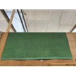 A LARGE GREEN PATTERN RUG