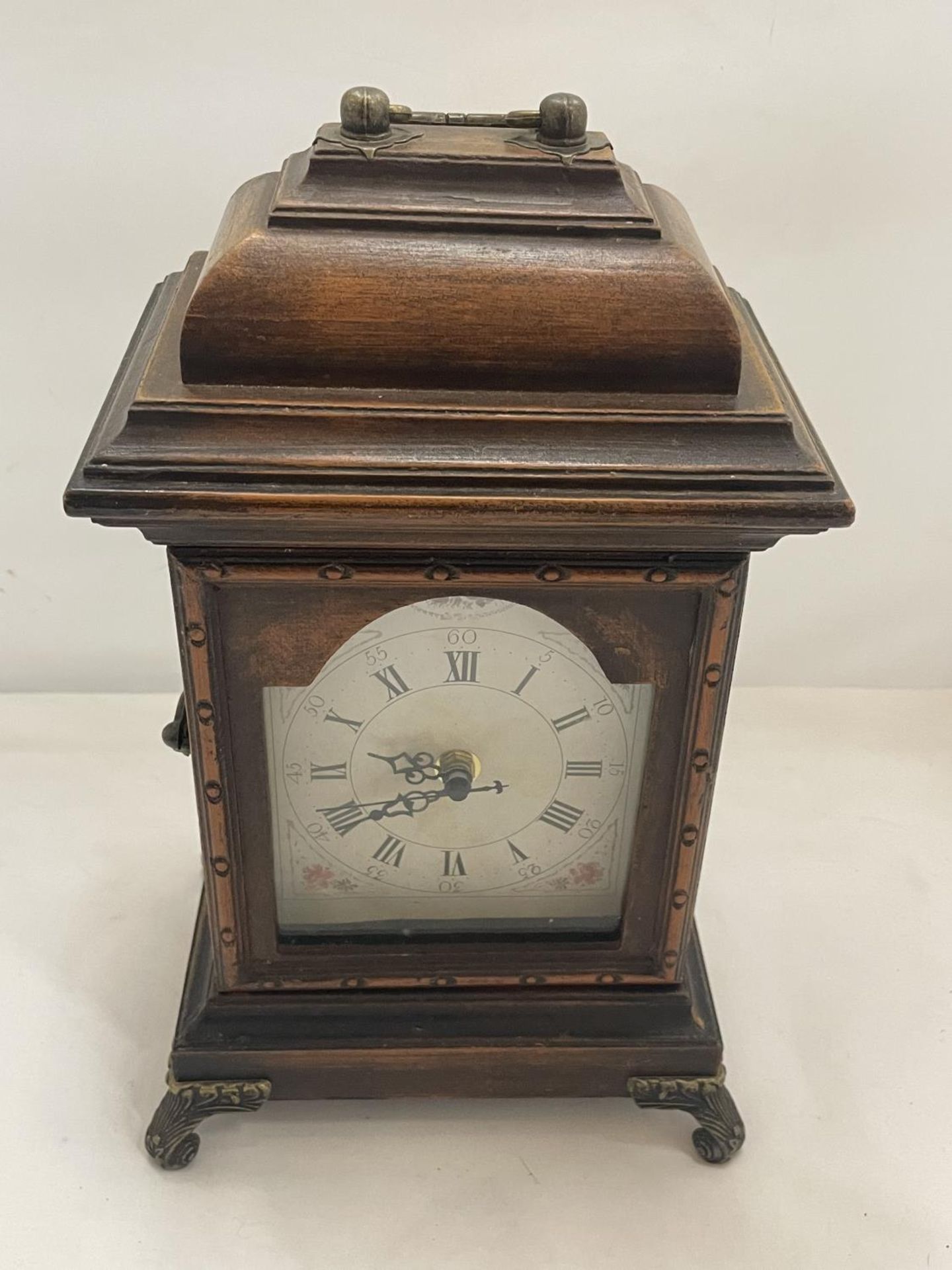 A SMALL CUPBOARD DISGUISED AS A MANTLE CLOCK
