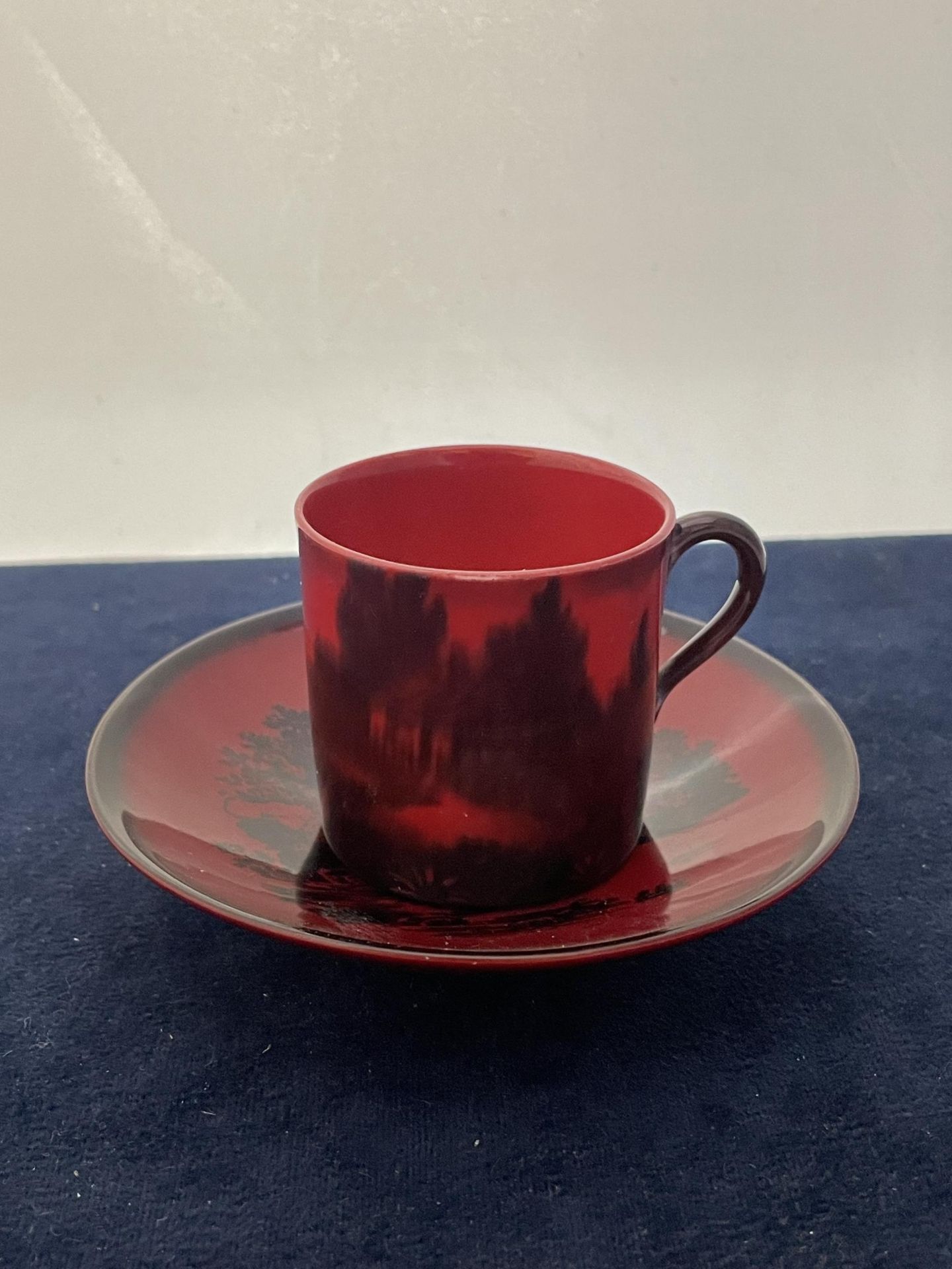 A ROYAL DOULTON FLAMBE CUP AND SAUCER- 6 CM