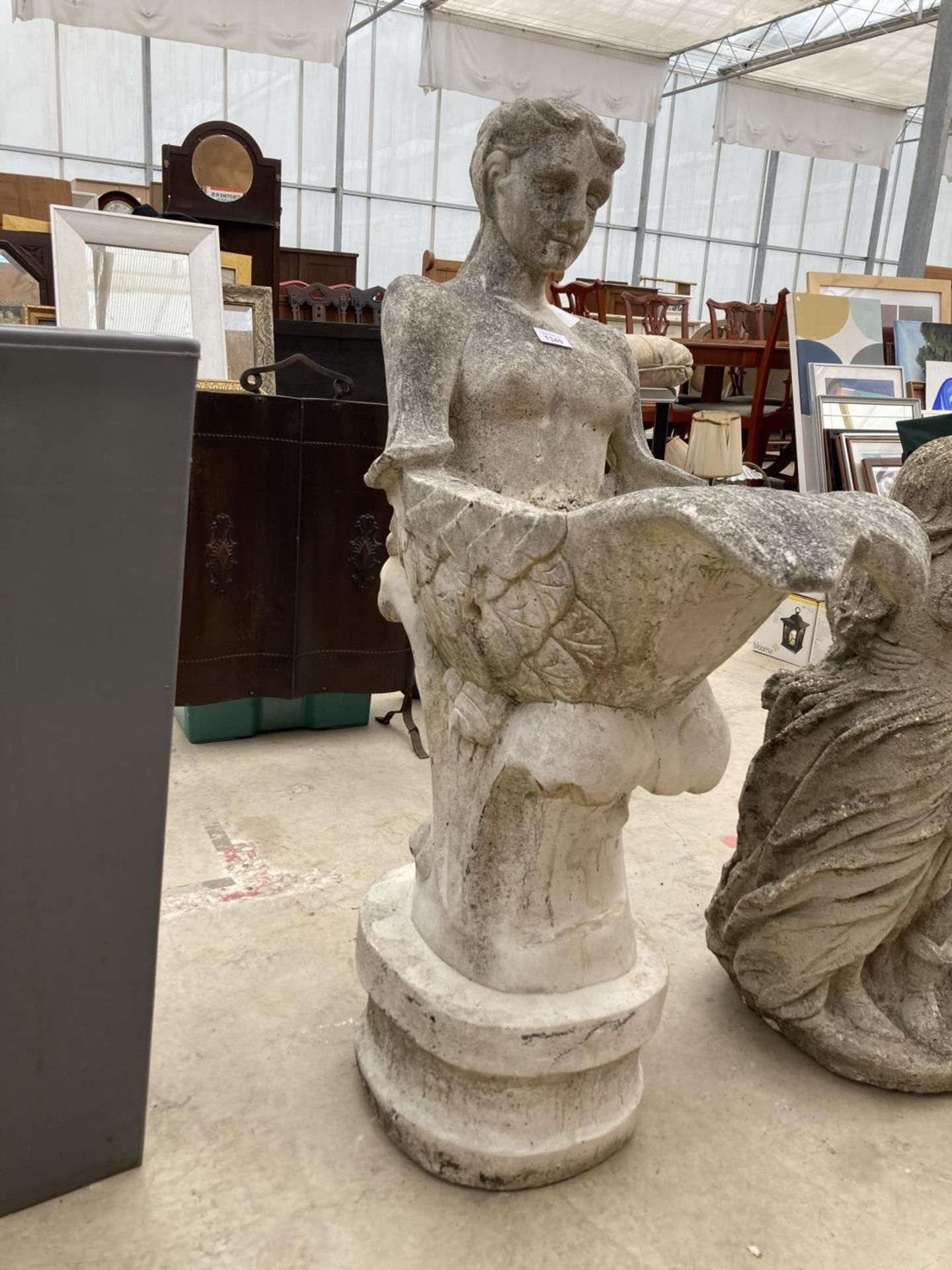 A RECONSTITUTED STONE BIRD BATH IN THE FORM OF A MERMAID