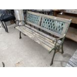 A WOODEN BENCH WITH CAST IRON ENDS AND BACK PANELS