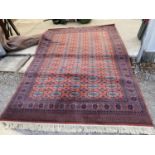 A LARGE RED AND BLUE PATTERN RUG