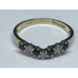 A 9 CARAT GOLD WISHBONE RING WITH FOUR SAPPHIRES AND THREE CUBIC ZIRCONIAS SIZE M/N