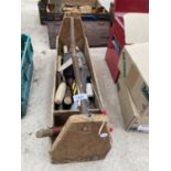 A VINTAGE WOODEN TOOL CARRIER TO INCLUDE TROWELS, SHARPENING STONE ETC