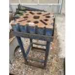 A VINTAGE SWAGE BLOCK ON A STAND 30CM X 30CM