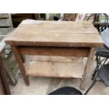 A WOODEN WORK BENCH/TABLE