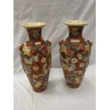 A PAIR OF ORIENTAL STYLE VASES WITH EMBOSSED DECORATION HEIGHT 45CM - A/F CRACKS TO BOTH