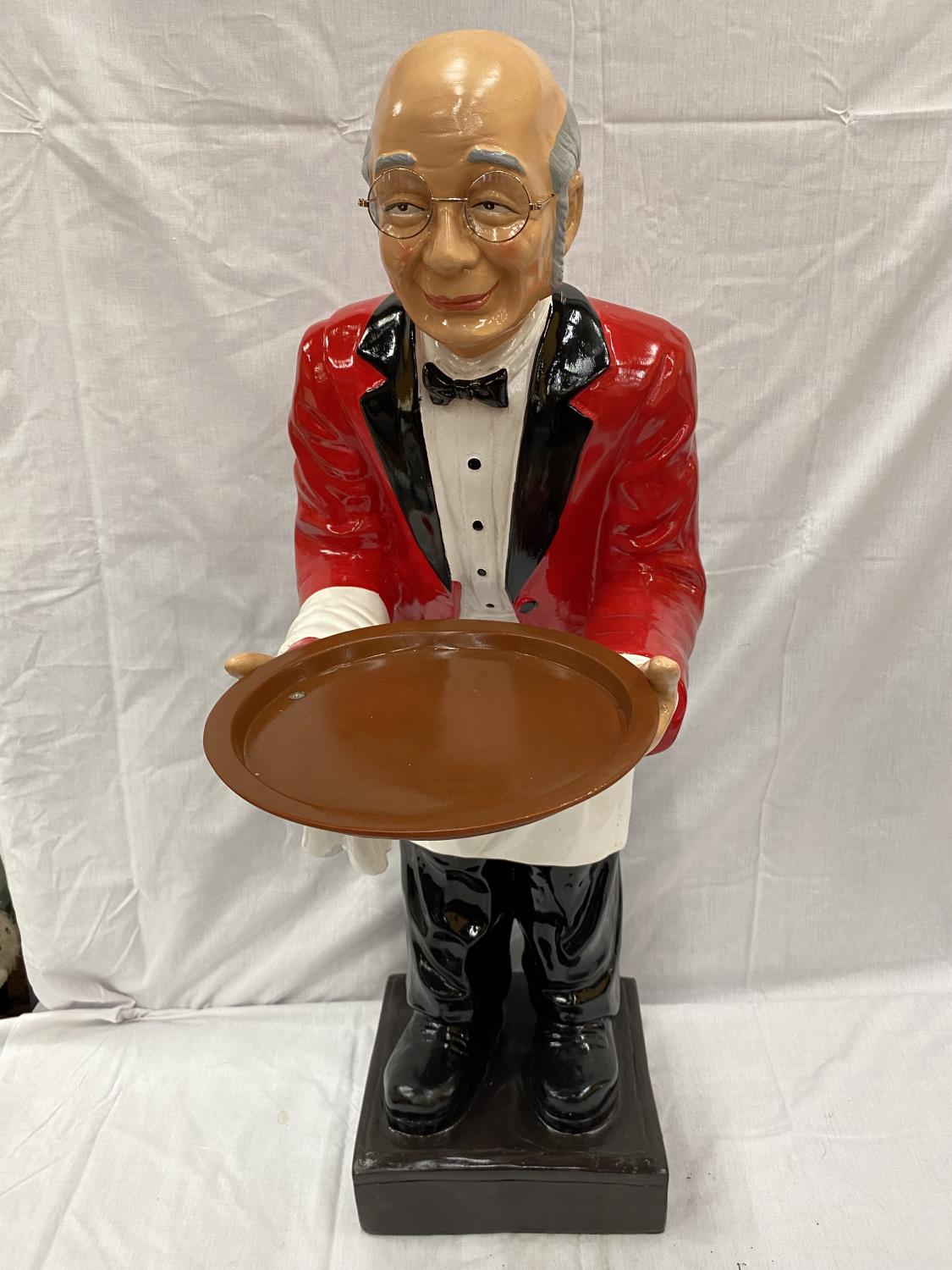 A DUMB WAITER DEPICTING A BUTLER IN A RED JACKET WITH A TRAY HEIGHT 96CM