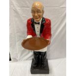 A DUMB WAITER DEPICTING A BUTLER IN A RED JACKET WITH A TRAY HEIGHT 96CM