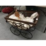 A VICTORIAN SPRUNG DOLLS PRAM MISSING HANDLE WITH CARRIAGE WHEELS TO INCLUDE A VINTAGE PORCELAIN