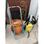 A KARCHER PRESSURE WASHER WITH A HOSE PIPE ON A REEL