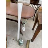 A GREEN PAINTED LONG HANDLED DOOR STOP