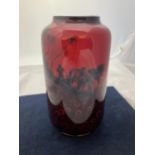 A LARGE ROYAL DOULTON FLAMBE VASE WITH FLOWER AND PLOUGHMAN DESIGN - 21.5 CM