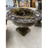 A LARGE RECONSTITUTED STONE URN PLANTER