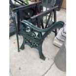 A PAIR OF CAST IRON BENCH ENDS, A SINGLE CAST IRON BENCH END AND TWO BUILDERS TRESTLES