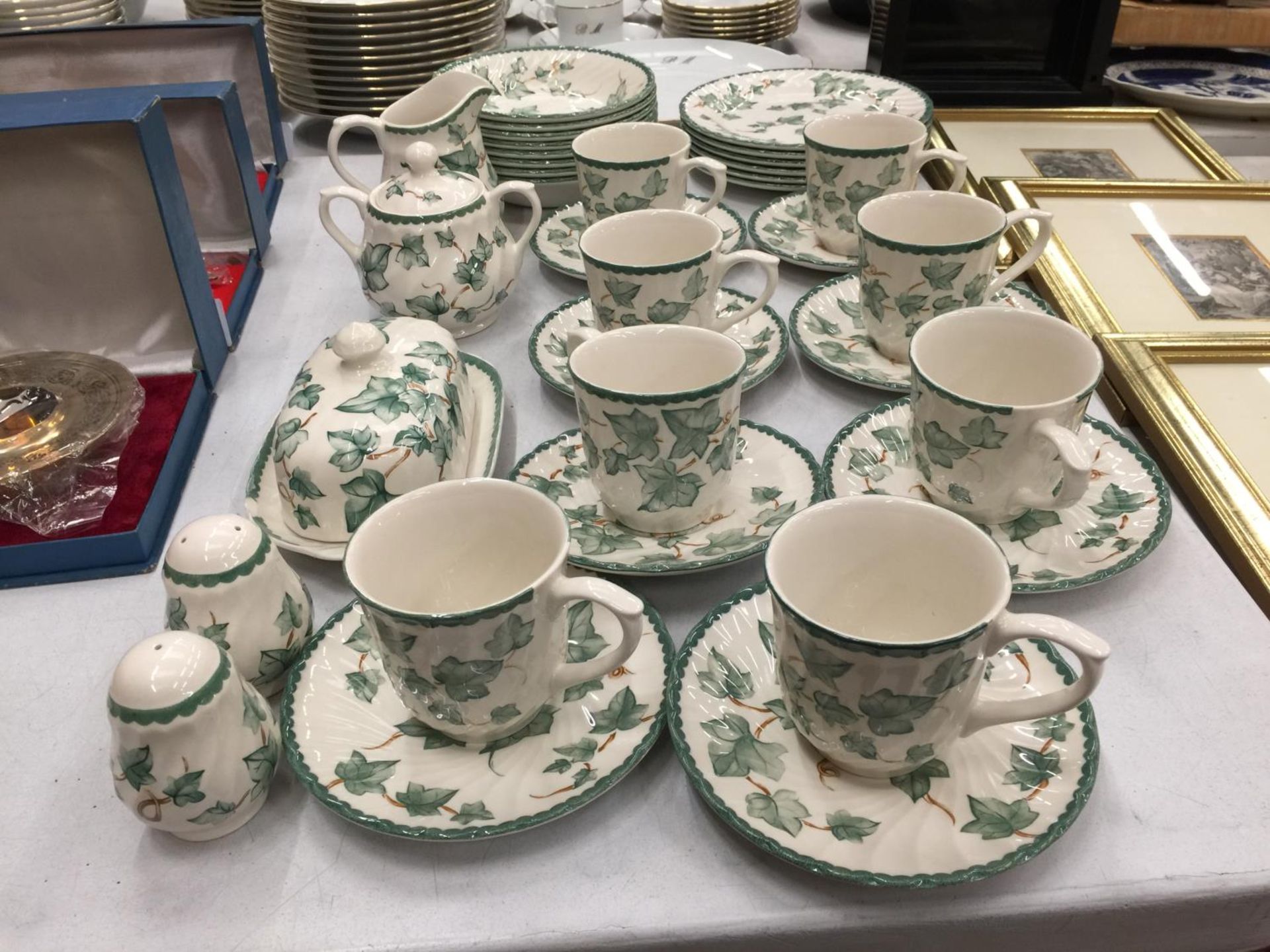 A QUANTITY OF CERAMIC TEAWARE TO INCLUDE CUPS, SAUCERS, PLATES, BOWLS, SUGAR BOWL, CREAM JUG, BUTTER