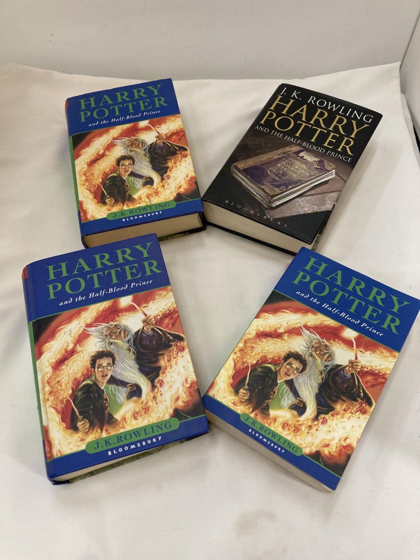 FOUR HARRY POTTER 1ST EDITION BOOKS TO INCLUDE ONE WITH A MISPRINT ERROR ON PAGE 99 WHERE THE WORD