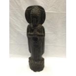 AN ASIAN WOOD CARVING OF A BUDDHIST STYLE PRAYING FIGURE H: 66CM