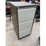 A BROWN AND CREAM THREE DRAWER METAL FILING CABINET