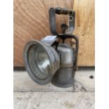 A VINTAGE HAND HELD PARAFIN POWERED LAMP