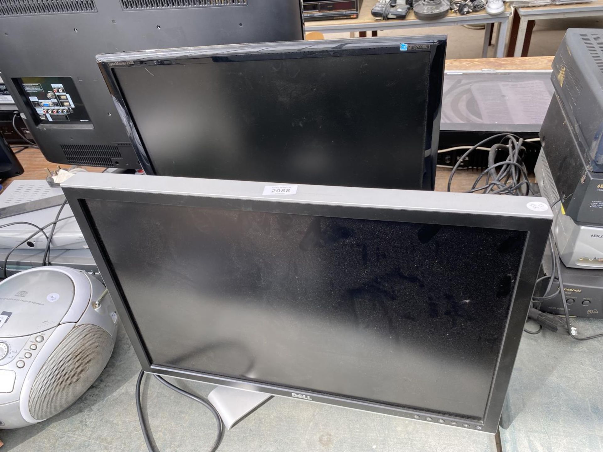 A SAMSUNG TELEVISION AND A DELL MONITOR