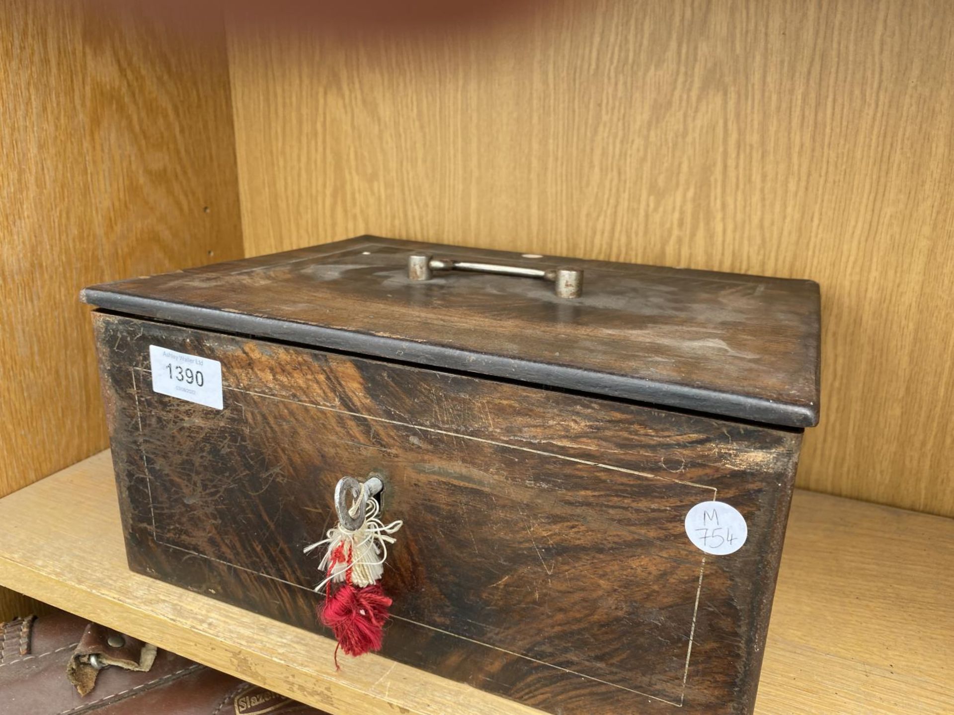 A VINTAGE METAL CASH TIN WITH DOUBLE LOCKING MECHANISM