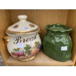 A LARGE DECORATIVE BREAD CROCK WITH FRUIT DESIGN AND A GREEN POTATO STORAGE POT