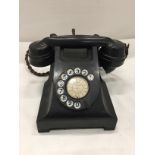 A VINTAGE BLACK BAKELITE TELEPHONE WITH FRONT DIAL - MISSING FRONT TRAY