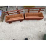 A PAIR OF WOODEN TROUGH PLANTERS WITH PLASTIC INSERTS