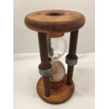 A LARGE VINTAGE WOODEN HOURGLASS HEIGHT 24CM