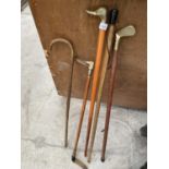 AN ASSORTMENT OF WALKING STICKS TO INCLUDE ONE WITH A BRASS DUCK HANDLE