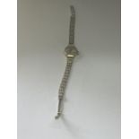 A LADIES 9CT GOLD 17 JEWEL INCABLOC AVIA SWISS MADE WATCH ON A 9CT GOLD GATE BRACELET STRAP