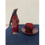 A ROYAL DOULTON FLAMBE CUP AND SAUCER- 6 CM A ROYAL DOULTON FLAMBE PENGUIN AF - DAMAGE TO BEAK AND