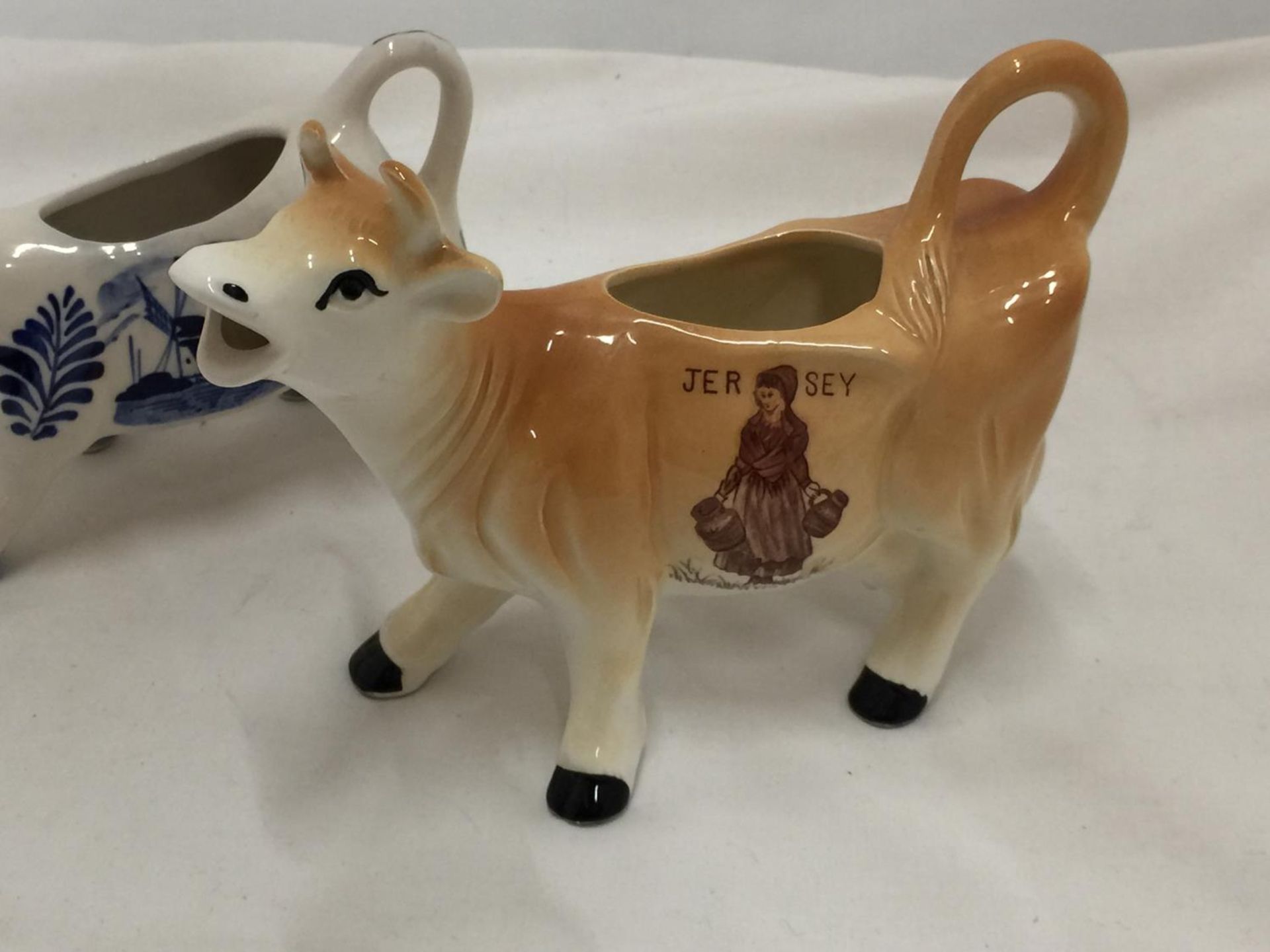 A DELFT BLUE HANDPAINTED COW CREAMER AND A JERSEY COW CREAMER - Image 2 of 7