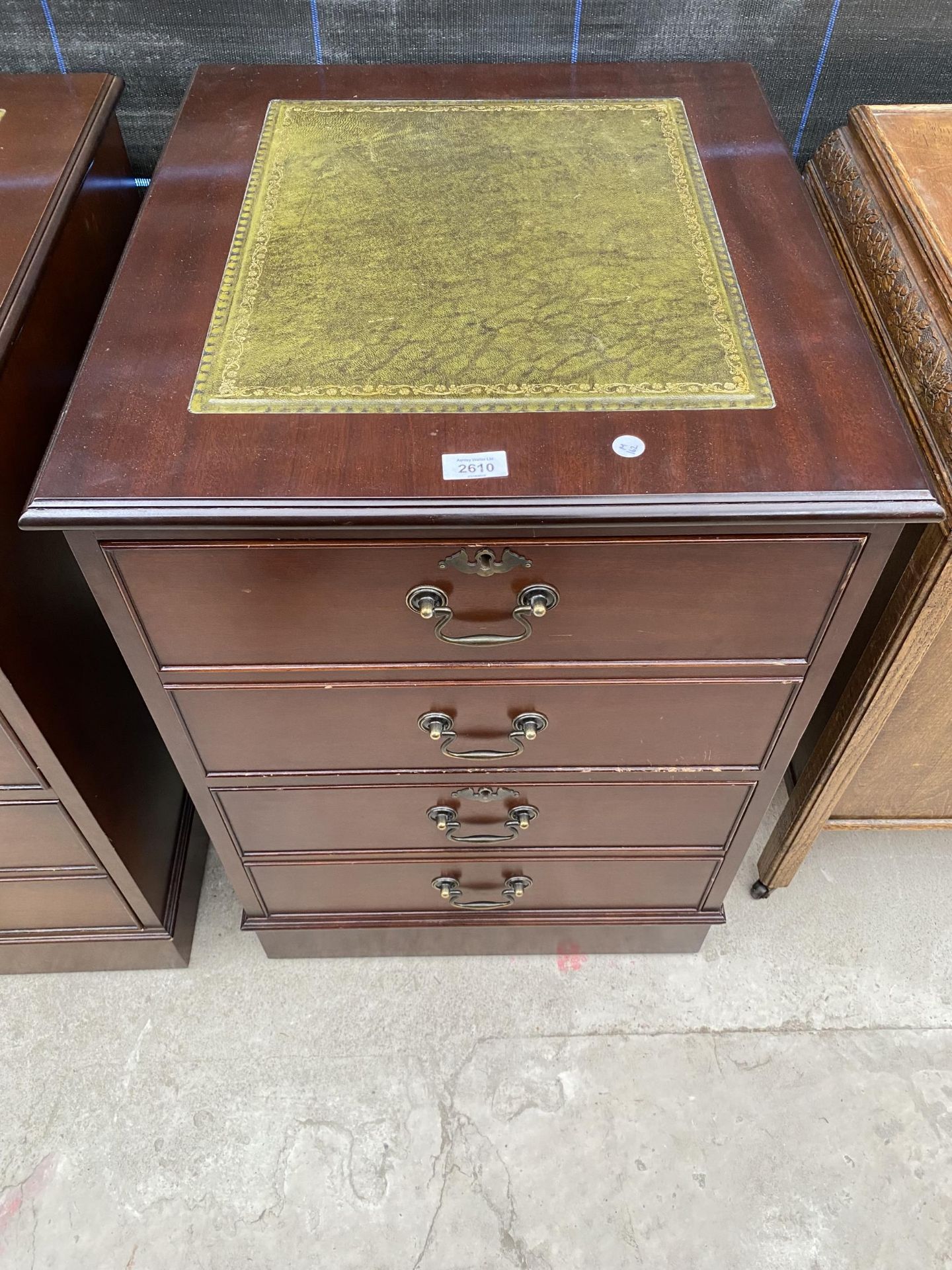A MAHOGANY TWO DRAWER FILING CABINET WITH INSET LEATHER TOP