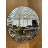 A LARGE CIRCULAR MIRROR WITH OUTER PATTERNED DETAIL