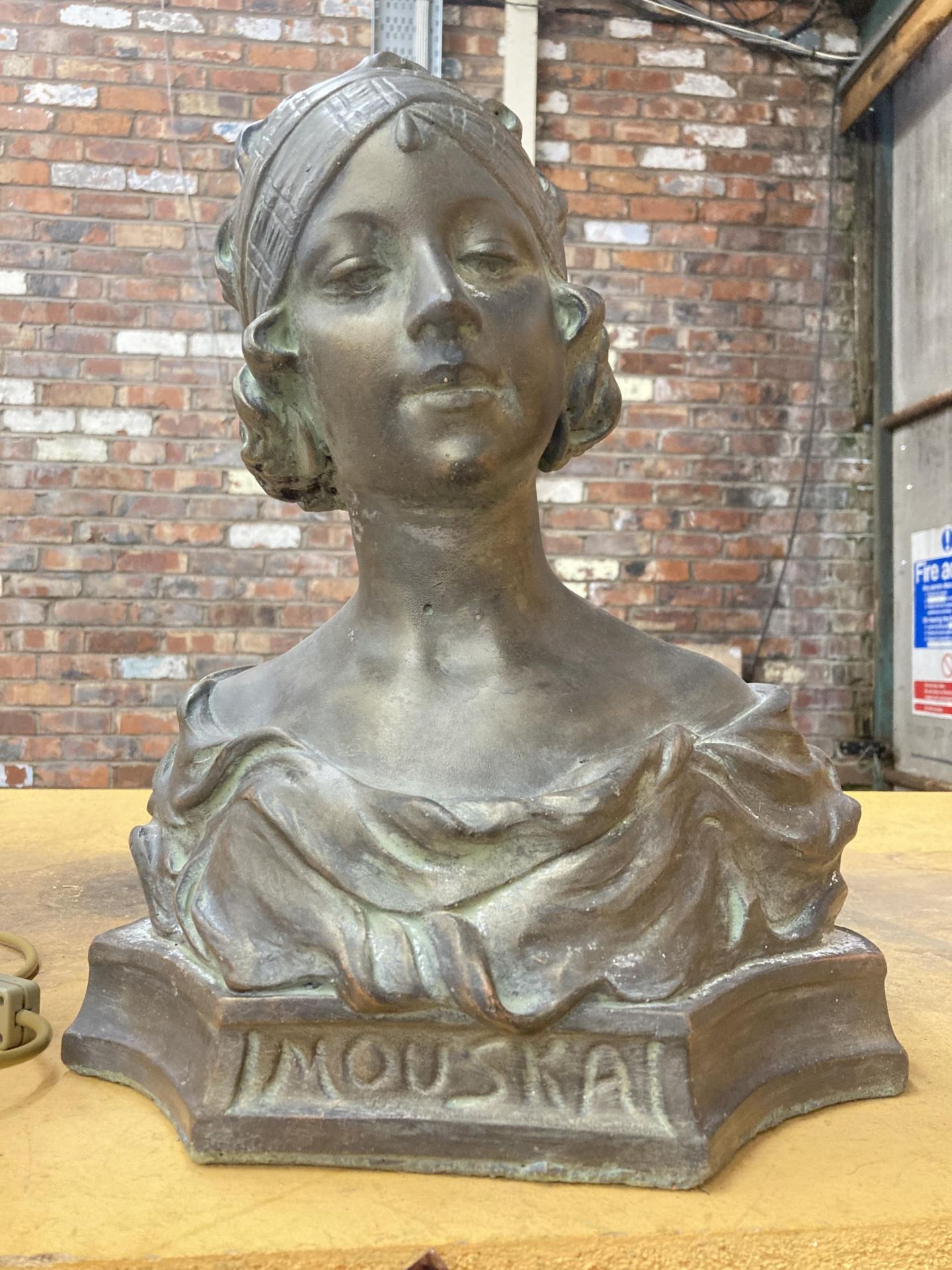 A RECONSTITUTED STONE 'BRONZED' BUST OF 'MOUSKA' HEIGHT 42CM, WIDTH 36CM