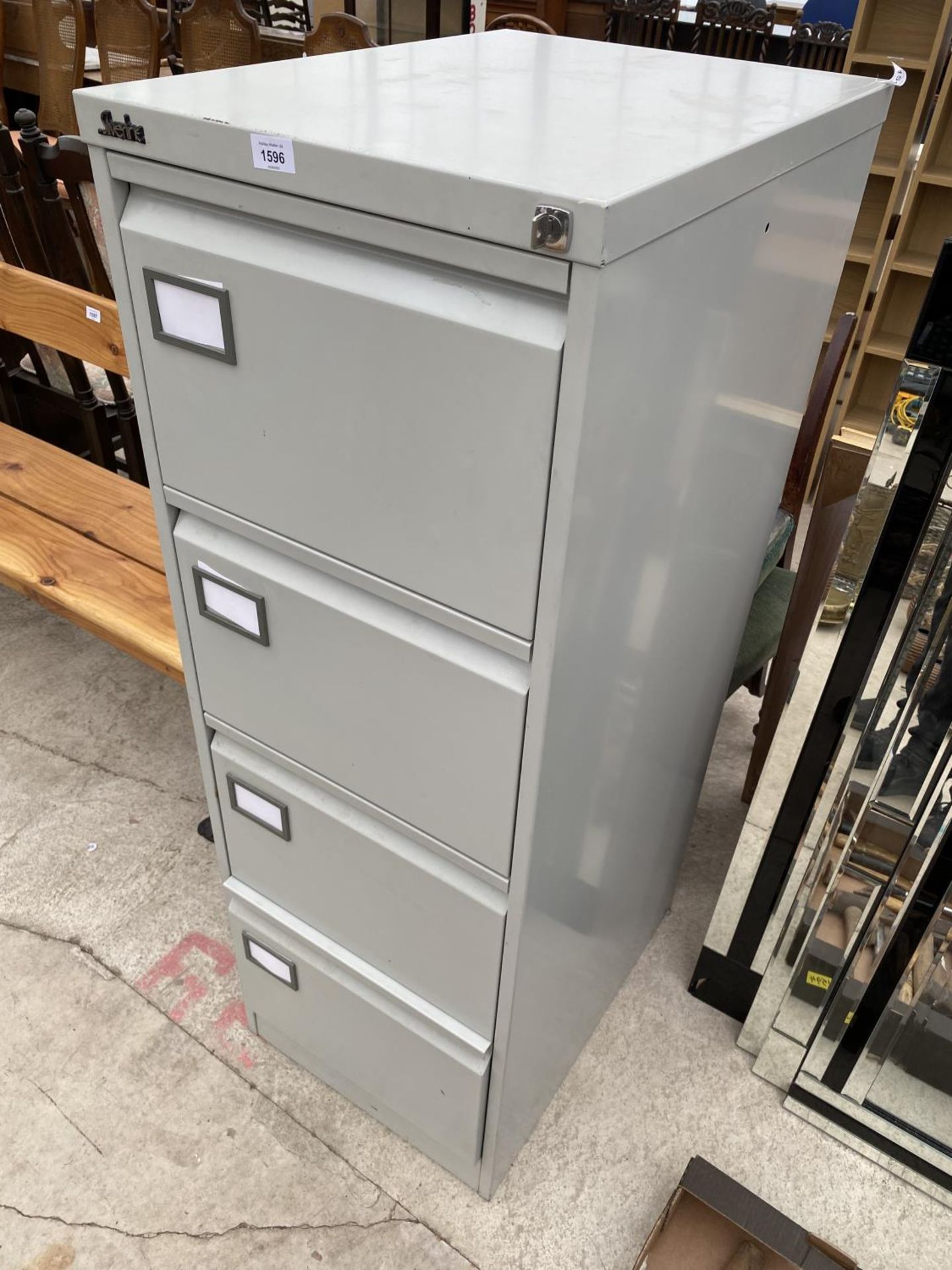 A SILVERLINE FOUR DRAWER FILING CABINET WITH KEY