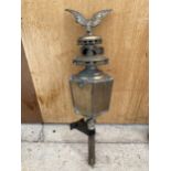 A VINTAGE BRASS COACH LAMP WITH EAGLE DETAIL TO THE TOP