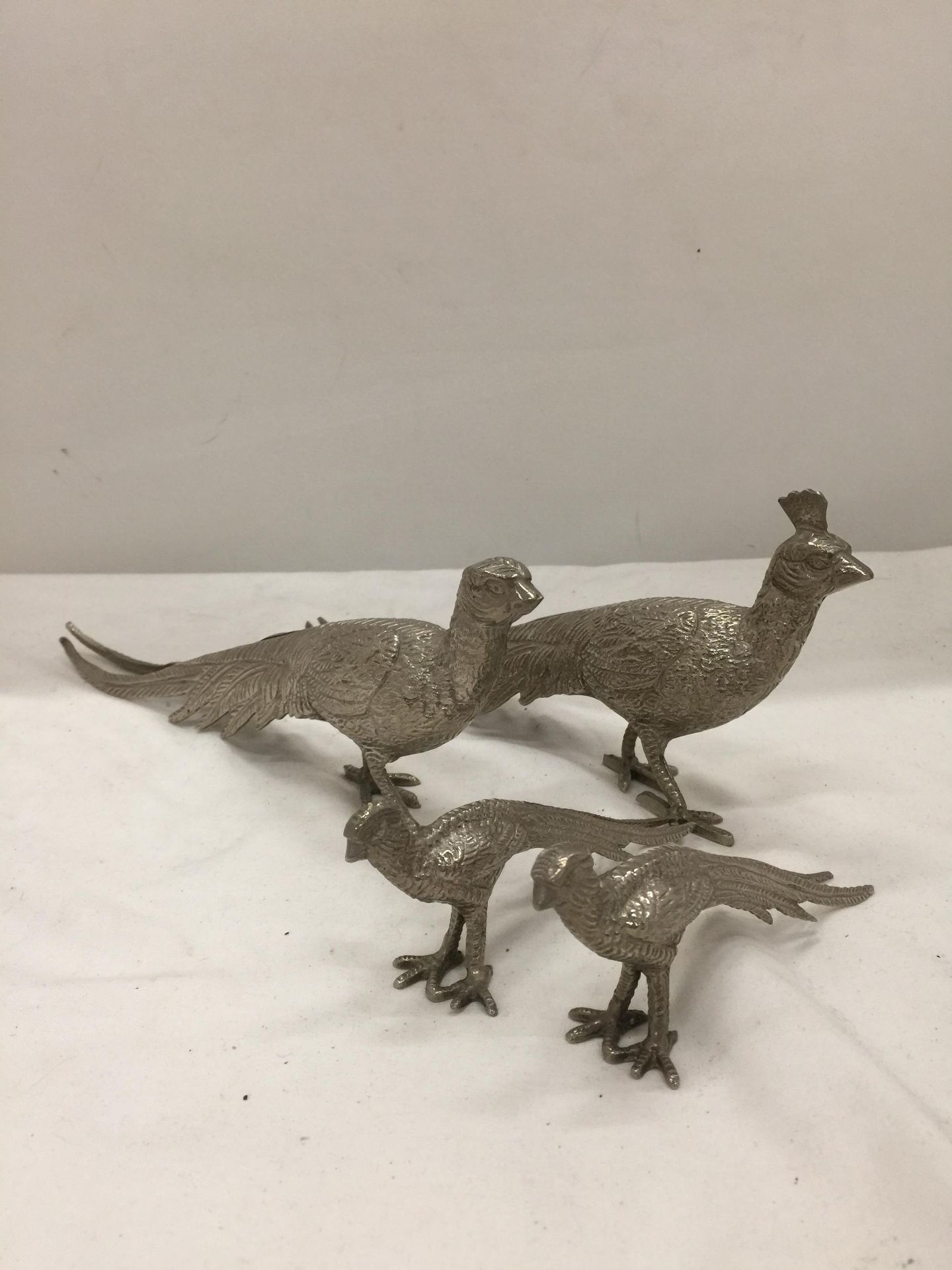 A LARGE AND SMALLER PAIR OF SILVER PLATED PHEASANTS