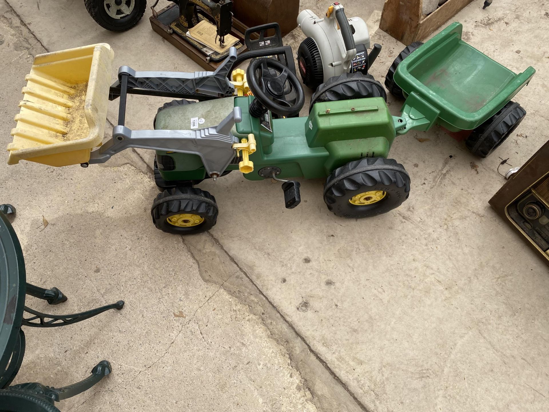 A PLASTIC JOHN DEERE PEDAL TRACTOR WITH TRAILER