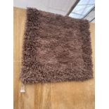 A MODERN BROWN RUG