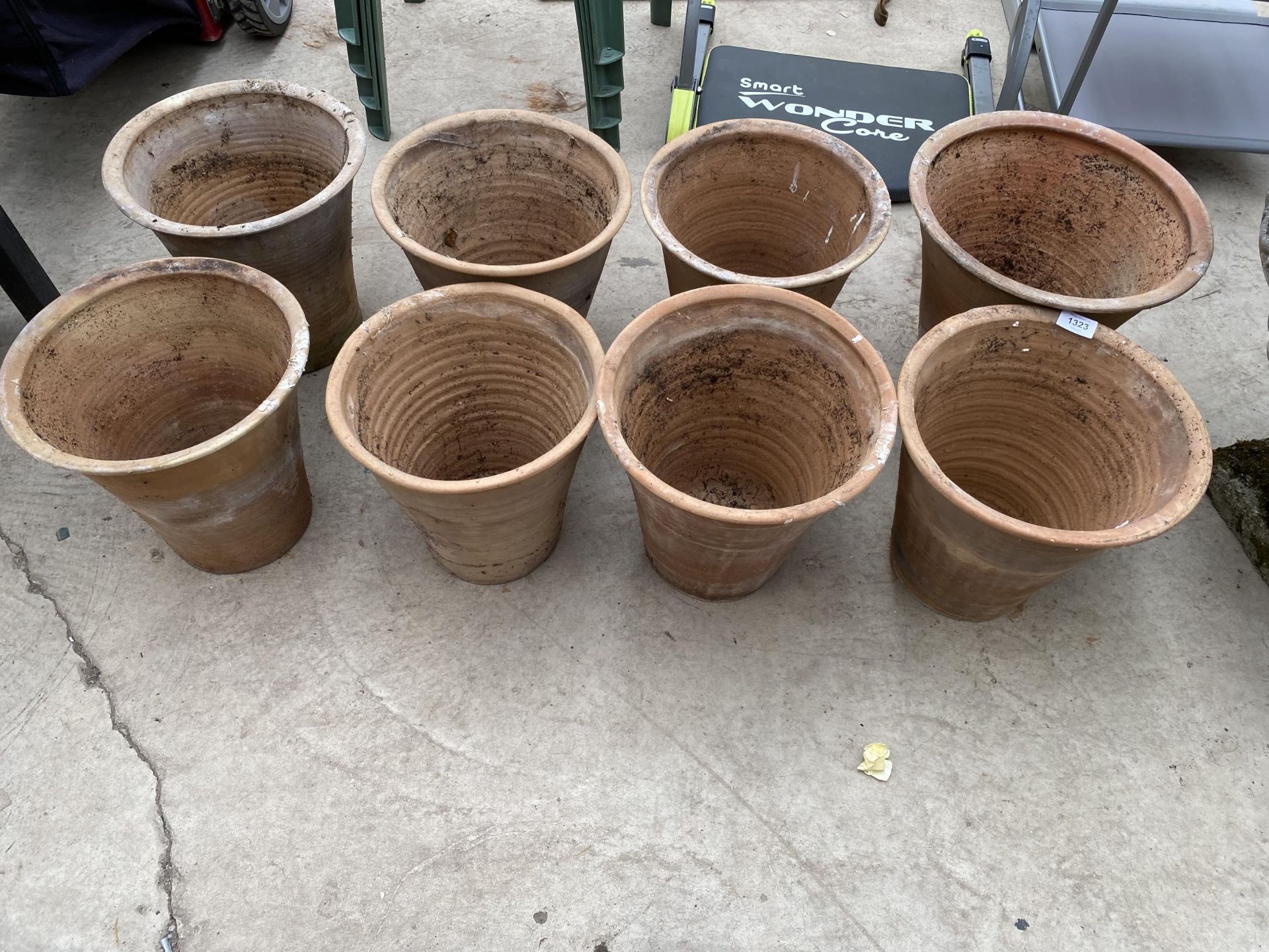 A COLLECTION OF EIGHT LARGE TERRACOTTA GARDEN POTS