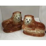 A PAIR OF MID CENTURY SADLER, BURSLEM RECLINING LIONS WITH GLASS EYES - A/F CHIPS TO BASE
