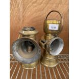 A NEAR PAIR OF VINTAGE BRASS PARAFIN LAMPS