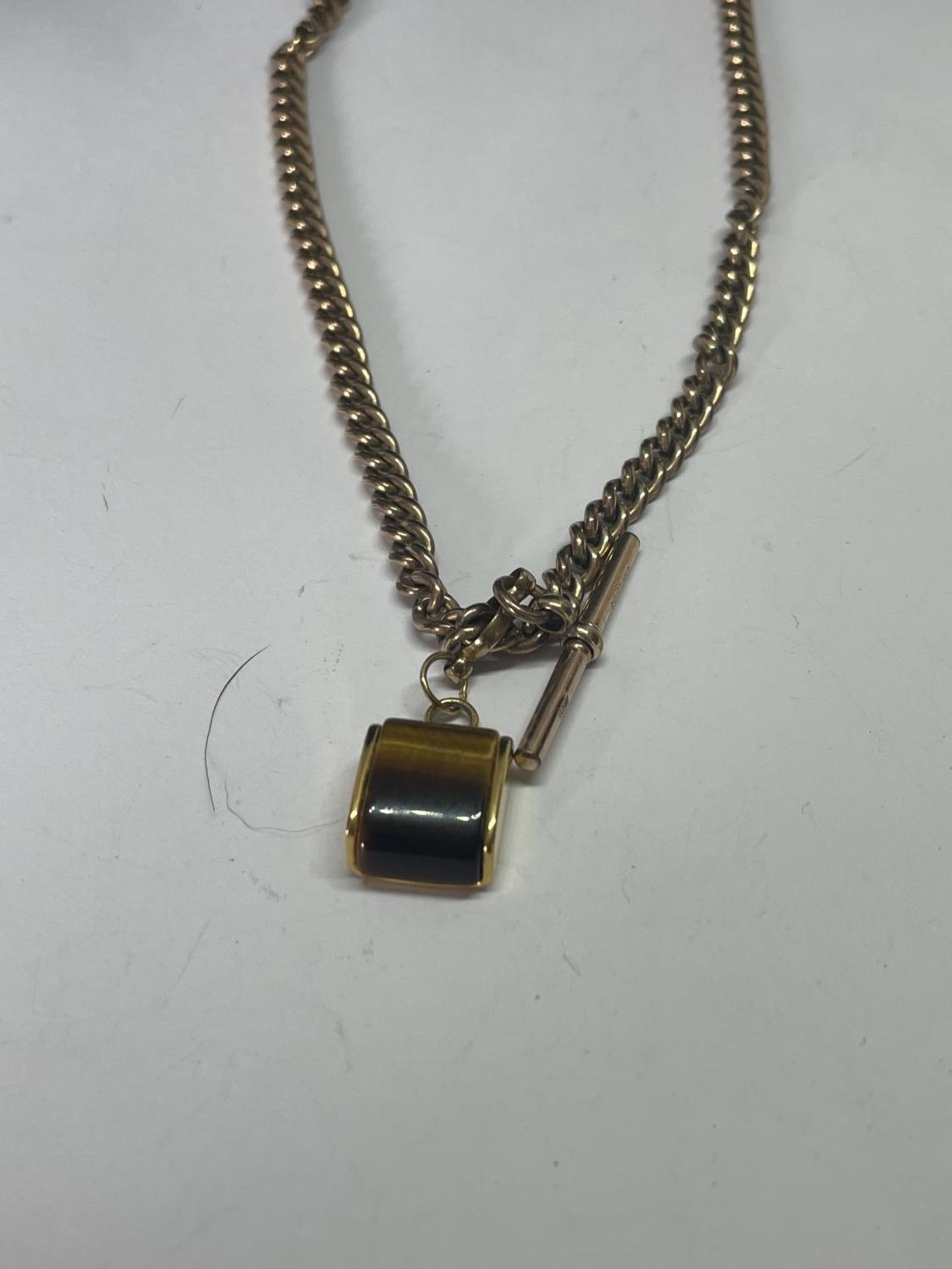A GOLD PLATED DOUBLE ALBERT WTACH CHAIN WITH T BAR AND FOB - Image 2 of 3