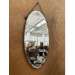 AN OVAL ART DECO BEVELED EDGE WALL MIRROR WITH HANGING CHAIN