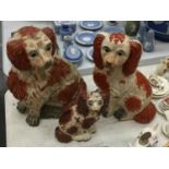 THREE VINTAGE RED AND WHITE SPANIEL MANTLE DOGS HEIGHTS 33CM, 31CM AND 19CM